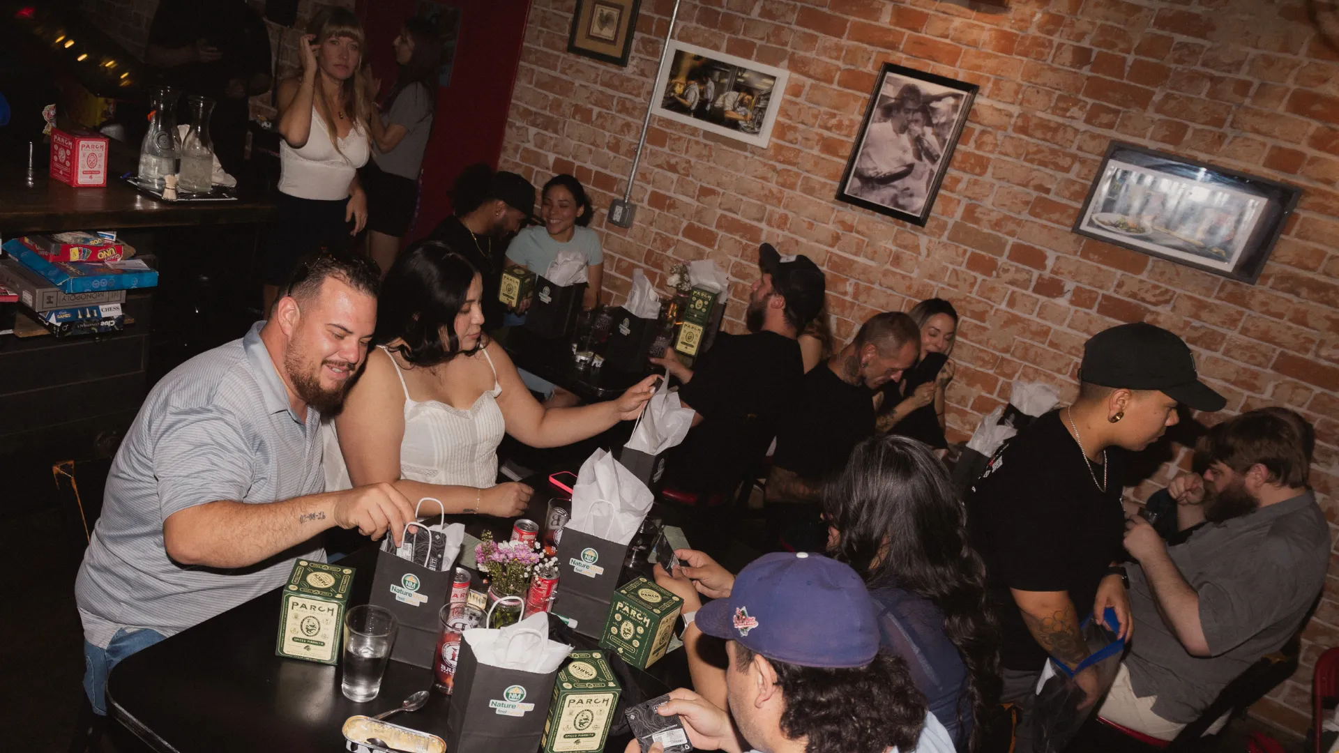A couple laughing and toasting drinks at a Doobie members event.
